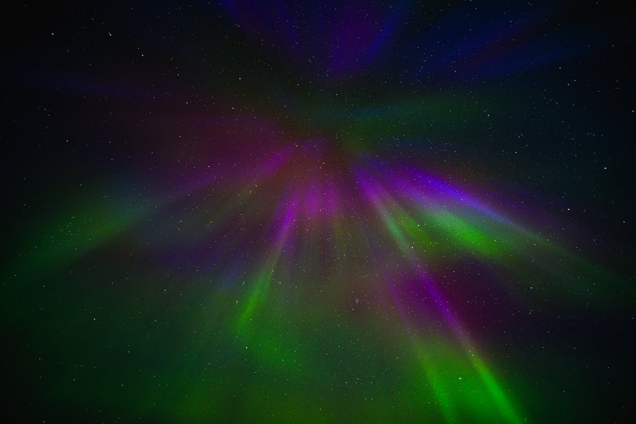 Vibrant aurora borealis spectacle in night sky showcases colorful light patterns.