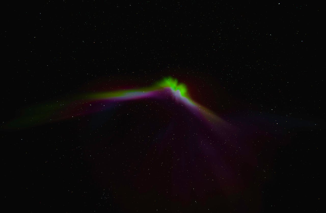 Captivating view of the aurora borealis illuminating the pitch-black night sky in Norway, a celestial wonder.